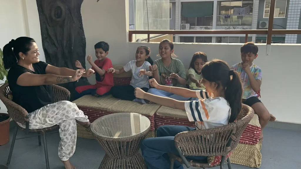Children participating in The Becoming emotional education program led by RasEsha Rabari in Ahmedabad to develop emotional awareness, confidence, and self-regulation.