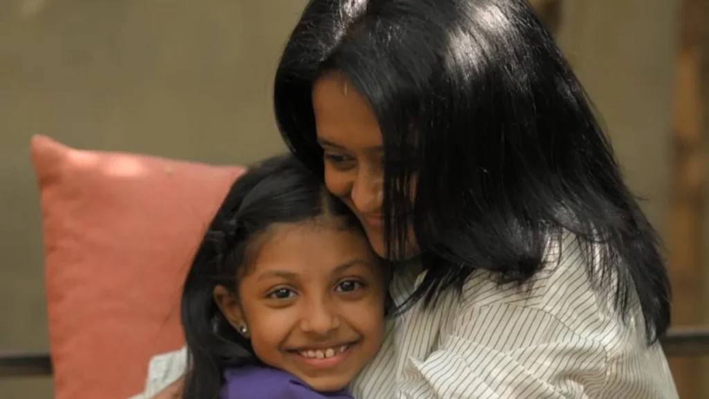 RasEsha Rabari hugging a smiling child, illustrating how emotional intelligence helps children build confidence, resilience, and secure relationships.